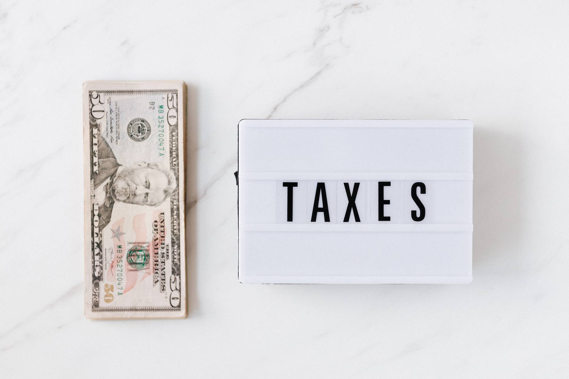 american dollar bills and vintage light box with inscription